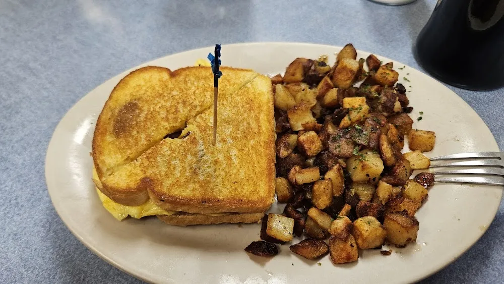Ham Egg and Cheese Sandwich and Sourdough Toast Along with Crispy Home Fries